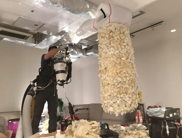 Fairhaven Air Duct Cleaning technician performing precision vacuum insulation removal in a residential property in Fairhaven
